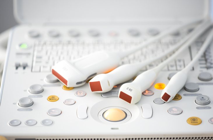 Ultrasound probes resting on the machine, ready for a study