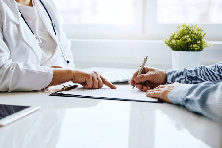 A clinician and patient going over information