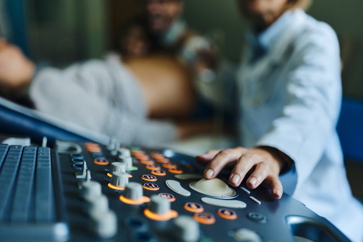 A sonographer at the ultrasound console during a study